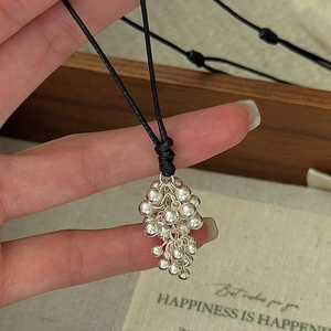 S925 sterling silver grape pendant necklace with adjustable black cord on a gift card