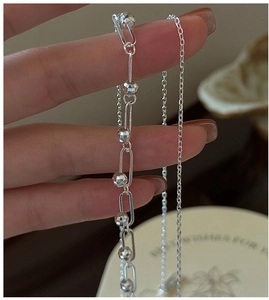 Close-up of 925 silver double-layered necklace featuring paperclip chain and faceted beads