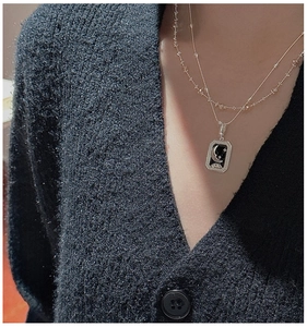 Detail of S925 silver layered necklace with vintage star and moon oil drip pendant