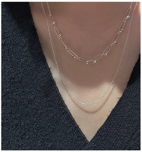 Detail of 925 sterling silver double-layered necklace with paperclip chain and beads