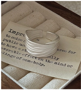 Macro shot of S925 sterling silver stamp on minimalist multi-layer textured ring
