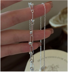 Detail of 925 sterling silver double-layered chain with rectangular links and faceted beads