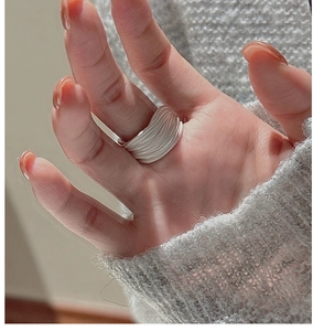 Macro detail of S925 sterling silver multilayer wavy band ring with matte finish