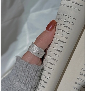 Detail of S925 sterling silver multilayer wire ring with a brushed matte finish
