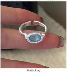 Detail shot of a S925 sterling silver matte ring with an oval aquamarine gemstone