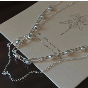 Detail of 925 sterling silver double-layer tassel necklace on festive gift card