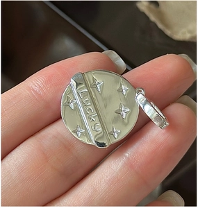 Macro view of S925 sterling silver Lucky pendant with engraved star textures