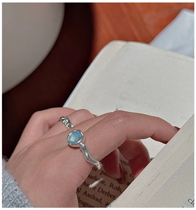 Macro detail of S925 silver ring featuring aquamarine stone and organic textured design