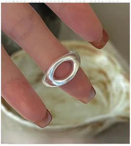 Minimalist silver hollow oval ring shown worn on a finger for a stylish lifestyle look