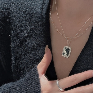 S925 sterling silver star moon pendant necklace and wide ring on model in dark setting