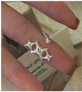 Close-up of S925 sterling silver star-shaped adjustable open ring on model finger