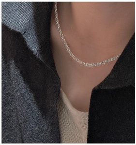 Close-up of minimalist S925 sterling silver chain necklace worn on neck for women