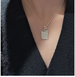 Macro shot of S925 silver rectangle pendant engraved with You deserve to be loved
