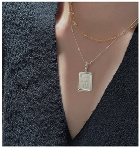 Detail of S925 sterling silver square pendant with 'You deserve to be loved' text