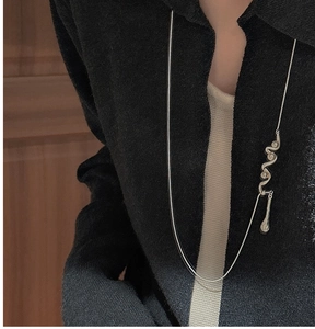 Detail of S925 sterling silver wavy pendant necklace with a minimalist teardrop charm