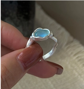 Close-up of S925 sterling silver ring with aquamarine stone and wavy texture detailing