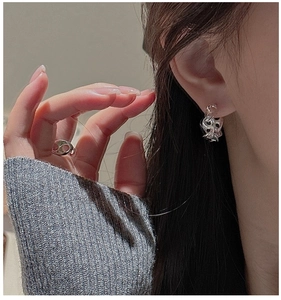 Close-up of S925 sterling silver earrings and ring with liquid lava texture