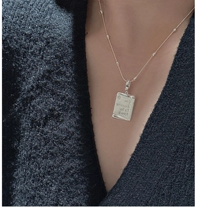 Detail of S925 silver rectangle pendant with 'You deserve to be loved' text and star