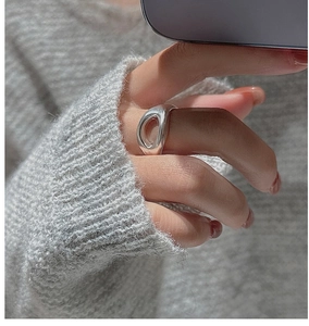 Close-up of minimalist S925 sterling silver irregular open ring worn on a hand