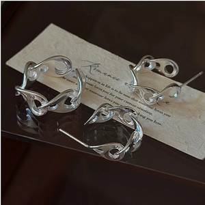 Macro shot of S925 sterling silver pig nose jewelry set with mirror polish on paper