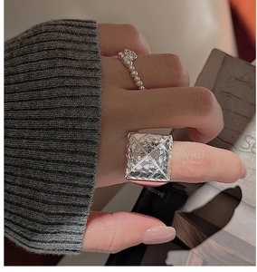 Detailed macro view of S925 silver ring set with large square zircon and beaded band style