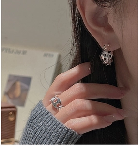Detail of silver S925 earrings and ring set featuring unique molten lava design and texture