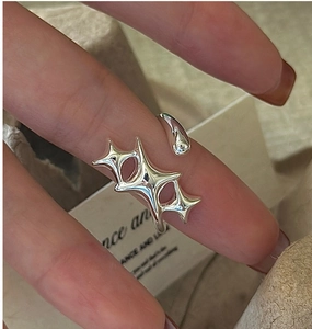 Close-up of S925 sterling silver adjustable ring featuring three minimalist star motifs