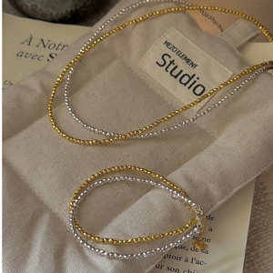 Detailed view of faceted S925 sterling silver bead bracelets in gold and silver finishes