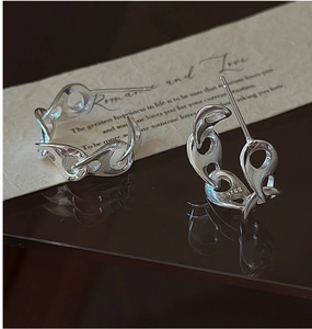 Close-up of S925 sterling silver pig nose earrings with unique liquid metal texture