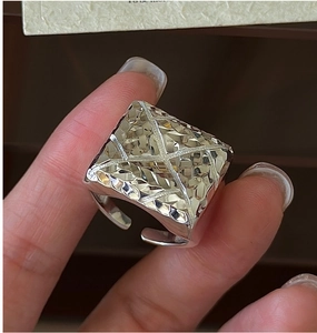 Detailed view of an open S925 silver ring featuring a bold geometric hammered texture