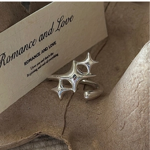 Detailed shot of S925 sterling silver star ring on vintage paper with romantic text
