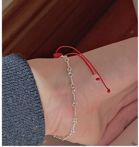 Detail of S925 sterling silver chain woven with red cord and adjustable clasp detail