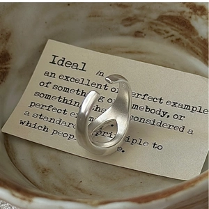 Detailed macro view of S925 sterling silver irregular wide twisted open ring on vintage card