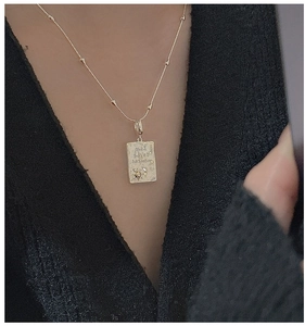 Detail of S925 silver rectangle pendant with Live in the moment text and moon pattern