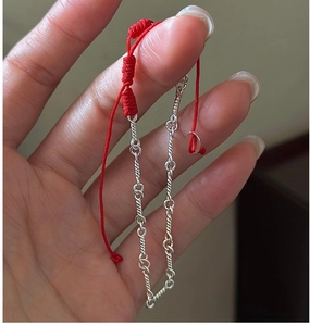 Detail view of S925 sterling silver chain merged with adjustable red woven rope bracelet