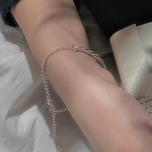Minimalist S925 sterling silver twisted rope bracelet on wrist with elegant lifestyle background