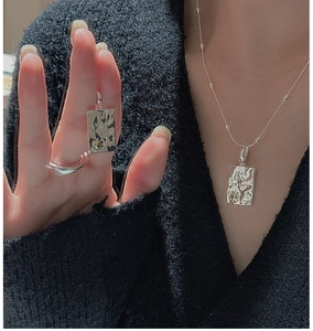 Detail of S925 silver rectangular pendant with lava texture and model wearing effect