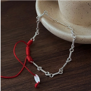 Detail of S925 sterling silver stamp and woven red rope on a vintage Chinese bracelet