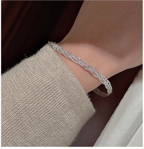 Macro detail of braided S925 sterling silver bracelet with Italy hallmark on the clasp