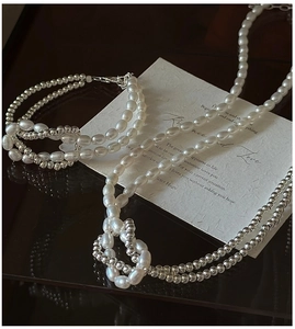 Détail de perles baroques et perles argentées sur le collier et le bracelet