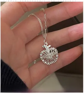 Detailed view of silver apple pendant necklace with radial texture on a delicate chain