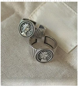 Macro shot of S925 sterling silver vintage portrait coin rings on canvas fabric