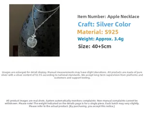 Macro detail of S925 sterling silver apple pendant with layered double chain design