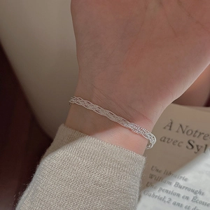 Minimalist S925 sterling silver woven multi-strand bracelet shown on female wrist