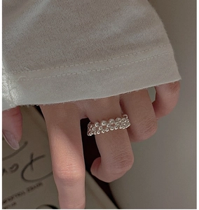 Detailed close-up of a minimalist S925 sterling silver double-row beaded ring on finger