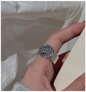 Macro shot of vintage S925 sterling silver ring with portrait relief and textured band