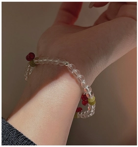 Close-up of a vintage cherry beaded bracelet worn on a wrist for a stylish fashion look