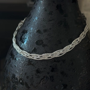 Handcrafted S925 sterling silver braided bracelet with high-polish metallic texture