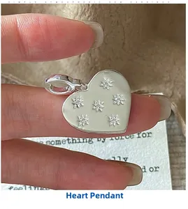Detailed view of an S925 sterling silver heart pendant with delicate star patterns