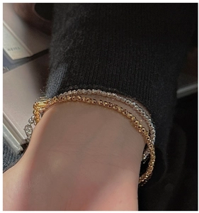 Detail of S925 sterling silver laser-cut bead bracelets in gold and silver finish